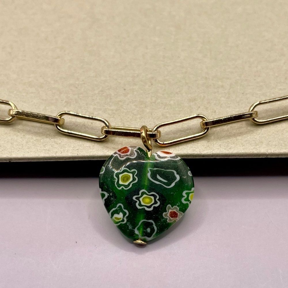 Urban Outfitters green millefiori glass heart pendant on a gold tone chain.